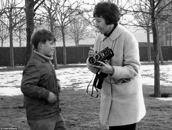 Prince Andrew, aged nine, talks with photographer Joan Williams about her camera in 1969